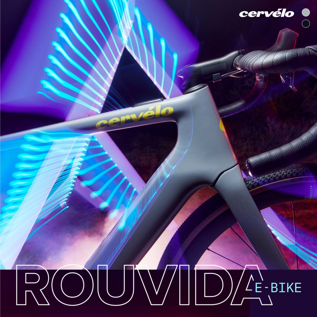 A dazzling image of multicolored light streaks enveloping the front half of Cervelo’s new Rouvida e-bike. Below are tech notes listing road and gravel disciplines, 1 by 12 SRAM and Shimano drivetrain options, and Fazua’s Ride 60 motor. 