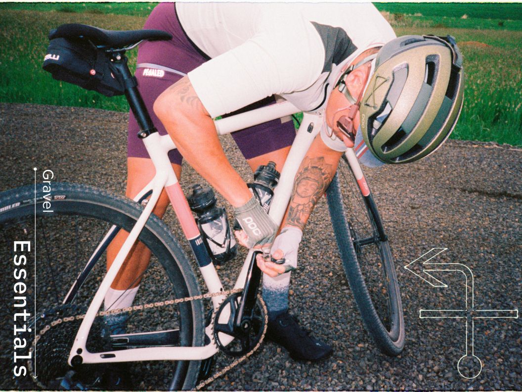 A gravel rider stops to adjust pedal spring tension while on a ride. 