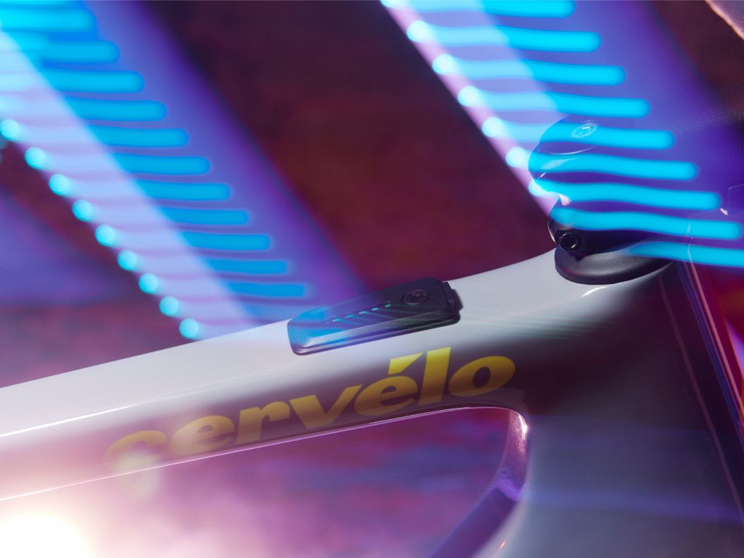 A dazzling image of multicolored light streaks enveloping the front half of Cervelo’s new Rouvida e-bike. 