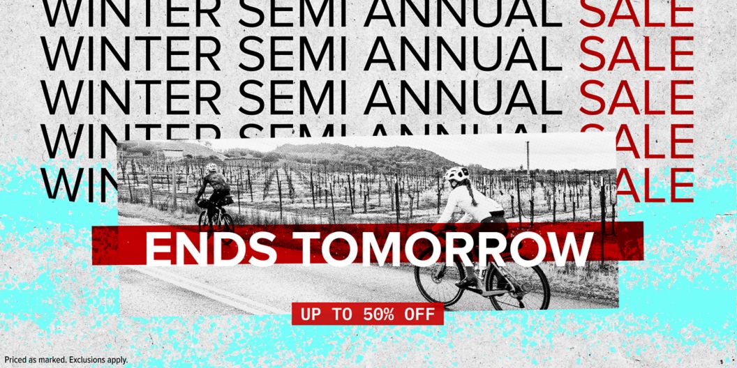 Winter Semi Annual Sale is repeated behind a black and white photo of cyclists riding by a vineyard. Up to 50% off ends tomorrow with a disclaimer of “priced as marked, exclusions apply.” 