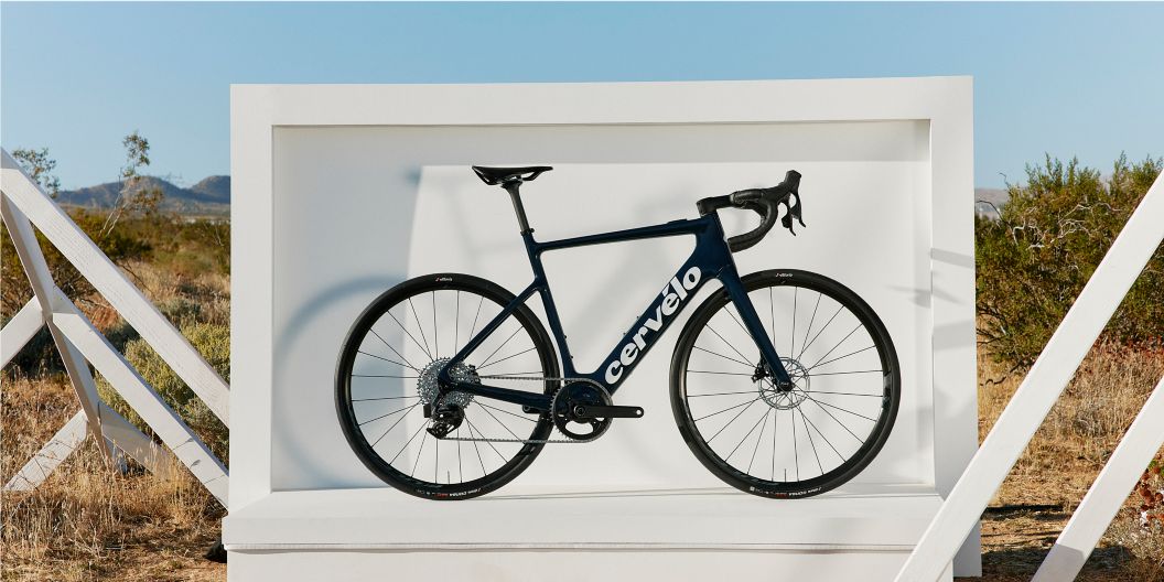 Cervelo’s new Rouvida e-bike standing in a white frame backdrop in a desert landscape.  