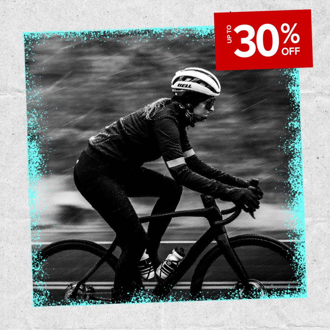 Up to 30% off discount sticker over a black and white image of a cyclist in winter kit on a rainy day.