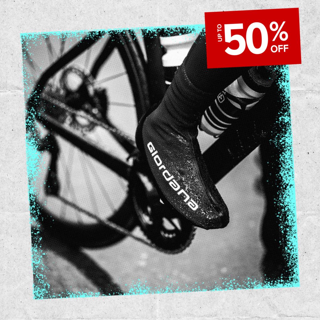 Up to 50% off discount sticker over a black and white image of a cyclist’s overshoes on a rainy ride.