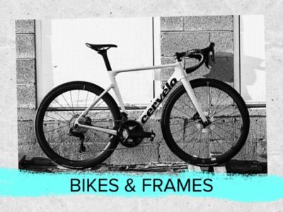 Bikes and frames text. A photo of a road bike against a wall. 