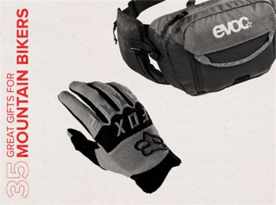 35 great gifts for mountain bikers text in red over an image of a pair of gloves and a hip pack.