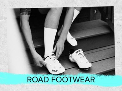 Road footwear text. A photo of a rider lacing up shoes.