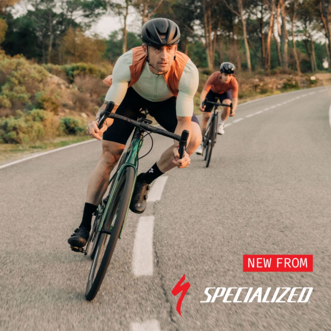 New from Specialized. Image features two road cyclists in spring kits descending a turn. 