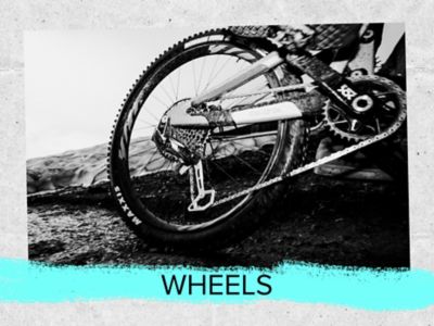 Wheels text. A photo of the rear wheel of a bike on a ride. 