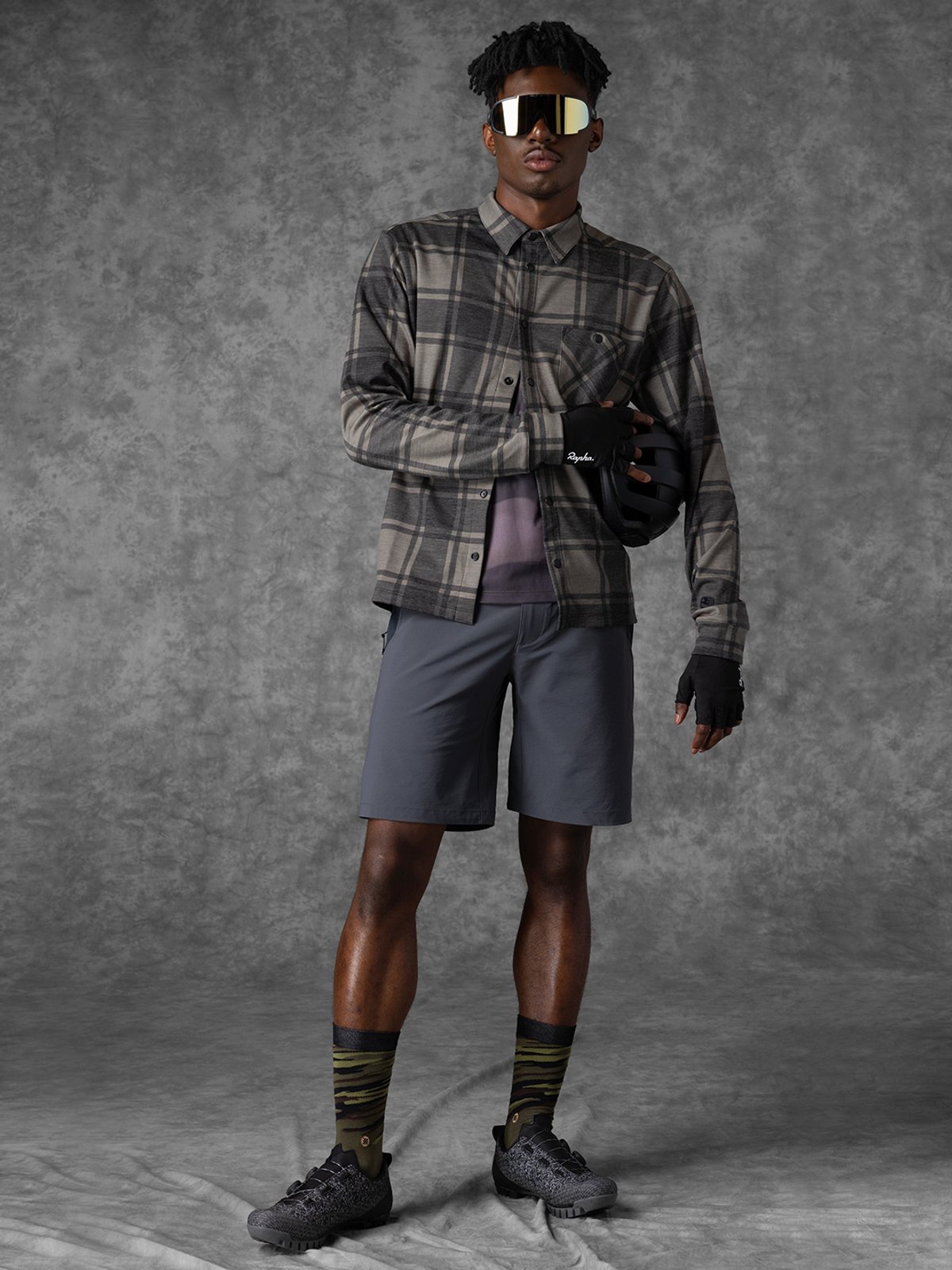 Men’s gravel MixFits kit #2 with a rider standing in the kit holding a helmet.