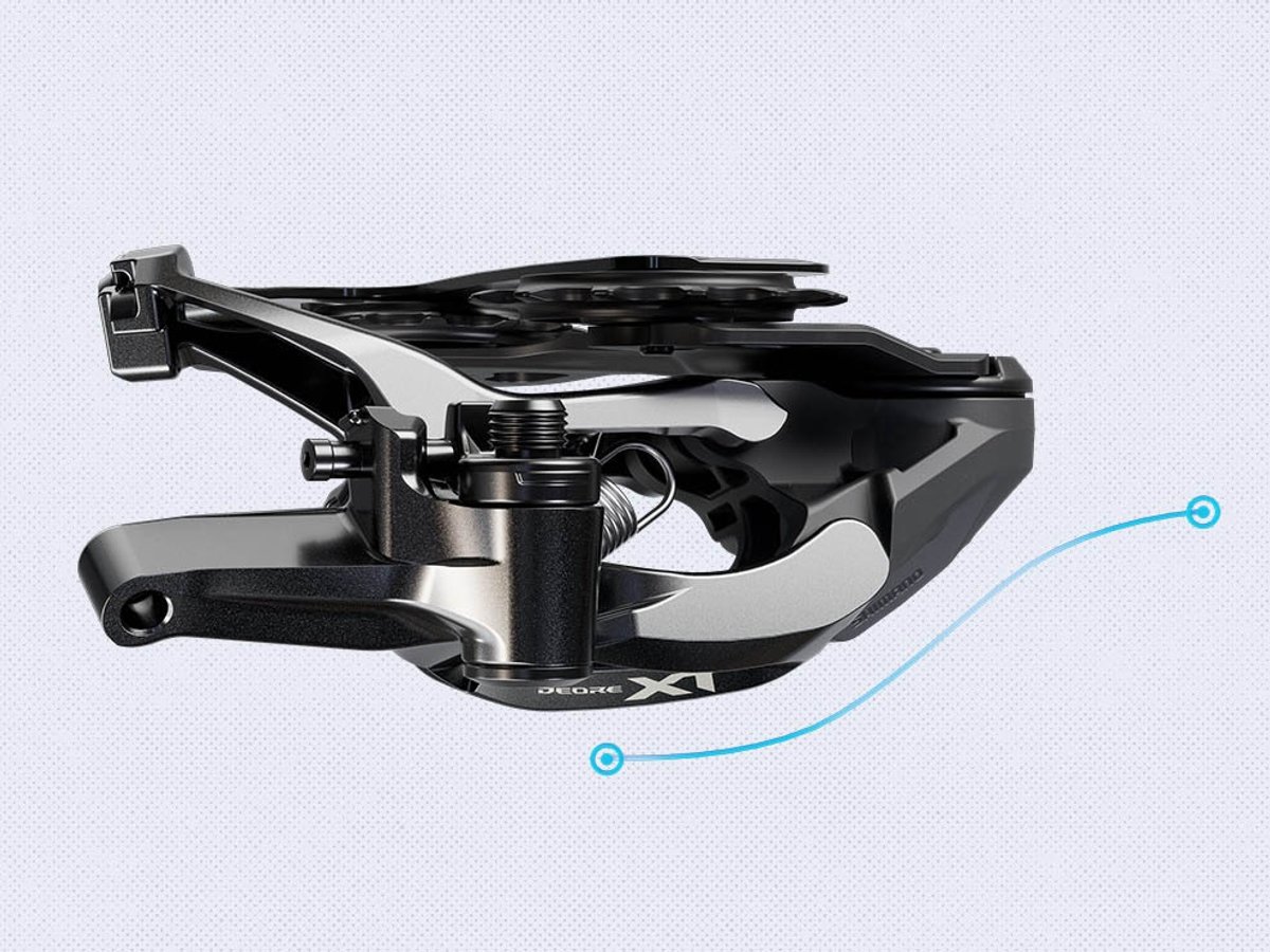 Shimano Deore XT rear derailleur, bottom view on a light gray background, with two blue callout points connected by a curved line.