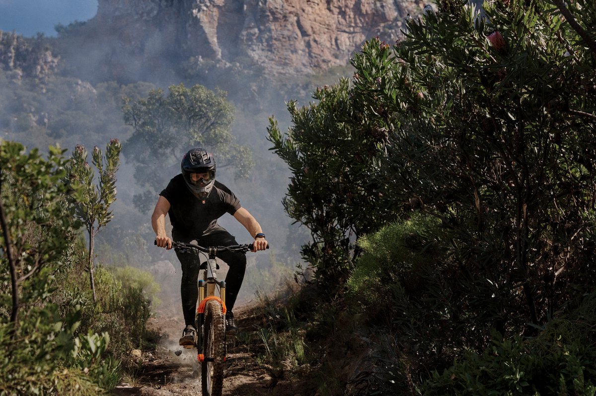 Person on mountain bike wearing Garmin Fenix 9 watch.