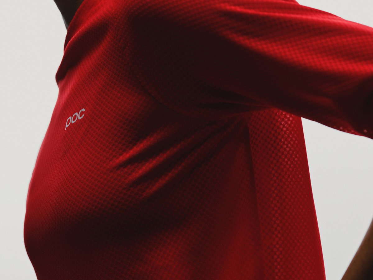Close-up of a cyclist wearing a red POC jersey.