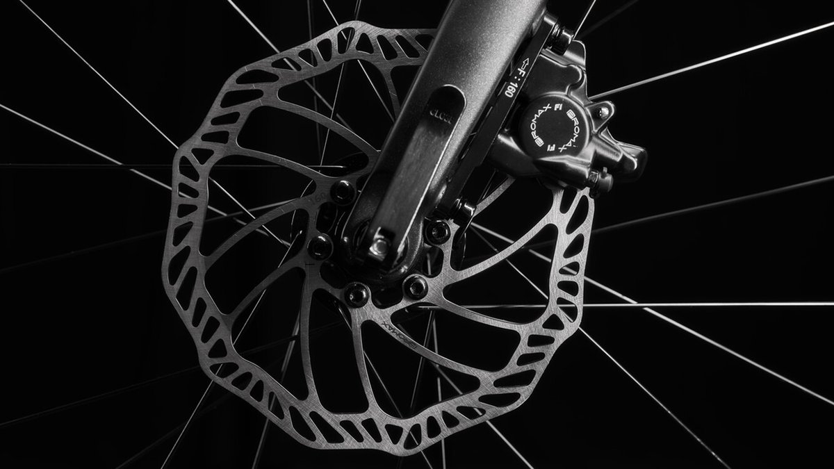 Detail shot of disc brake caliper and rotor.