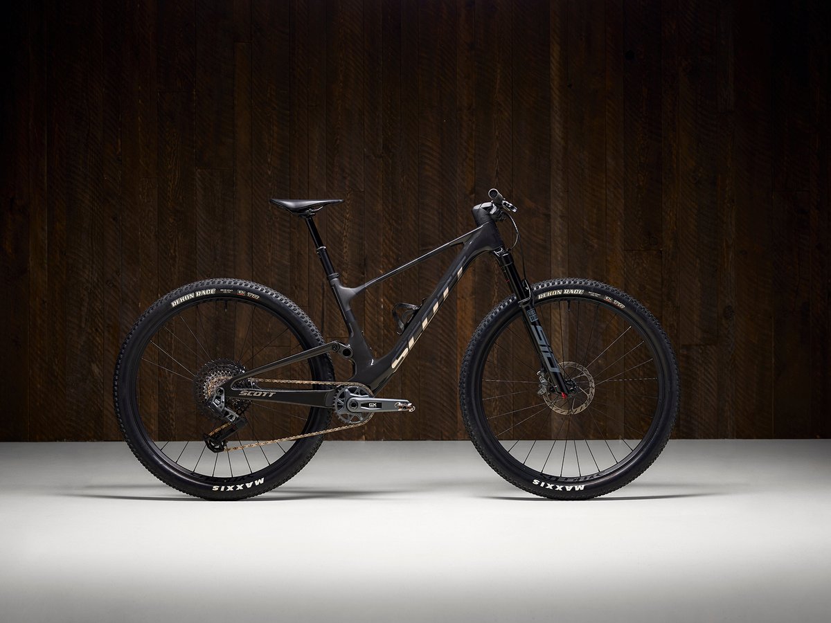 Scott Spark mountain bike shown against a dark wood studio background.
