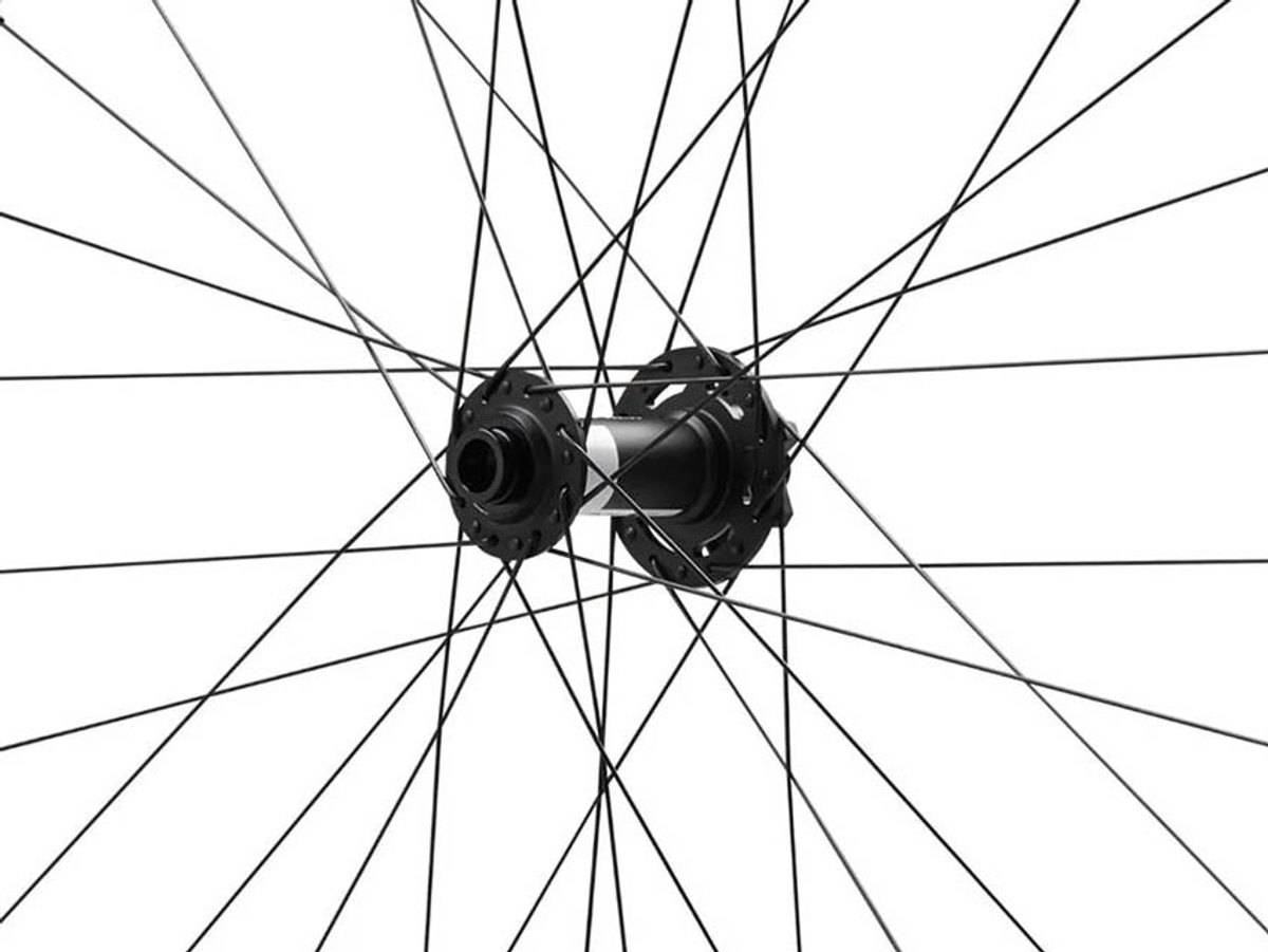 Reserve mountain bike wheel hub centered on white background, showing black alloy front hub with flanged spoke holes and straight-pull spokes radiating outward.