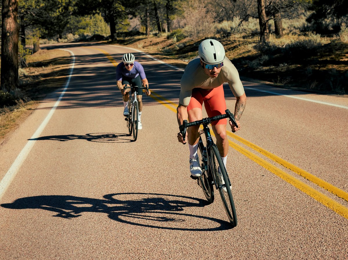 Two road riders mid-climb.
