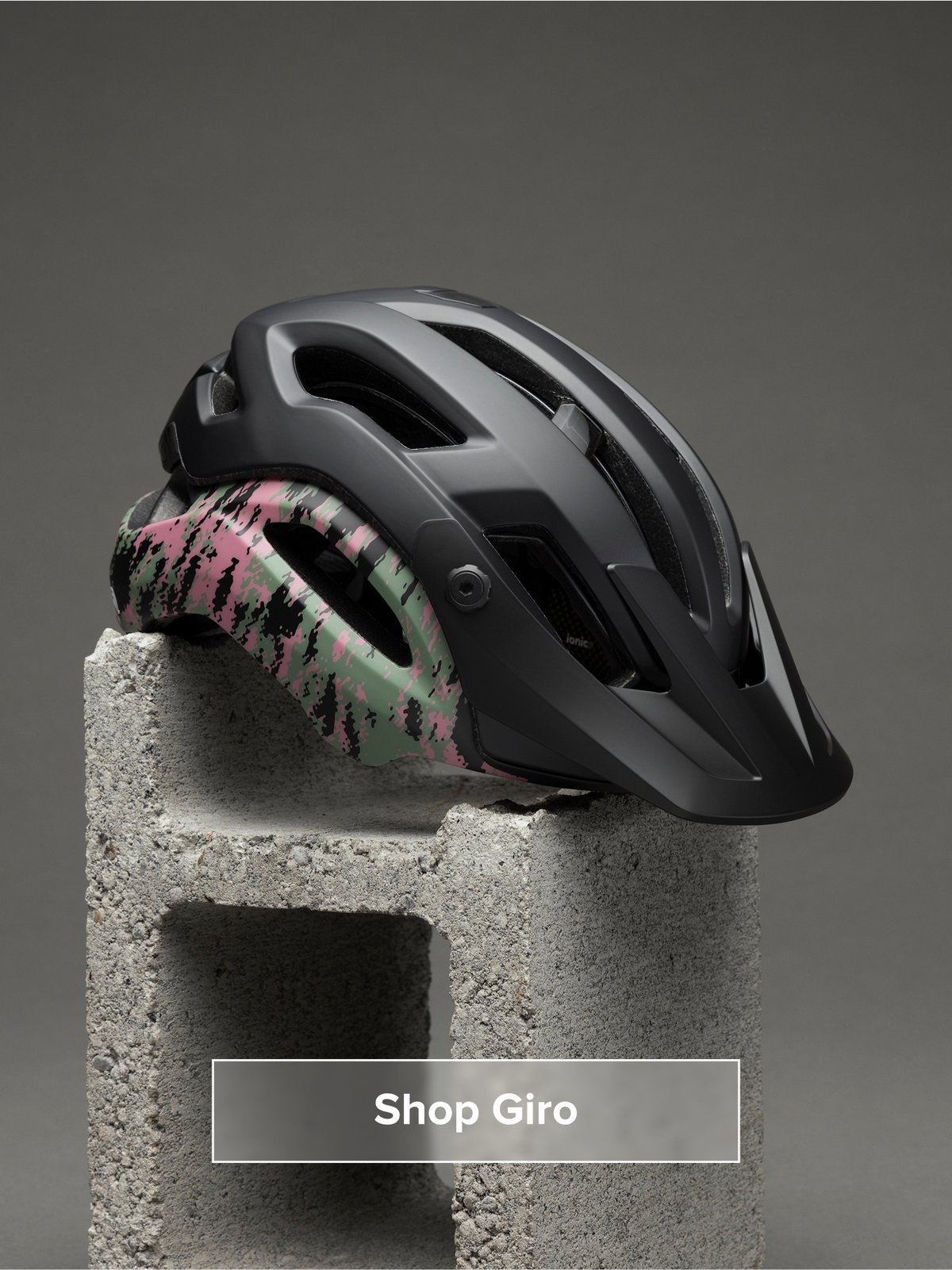 A helmet sits on a cinder block. Button reads: Shop Giro
