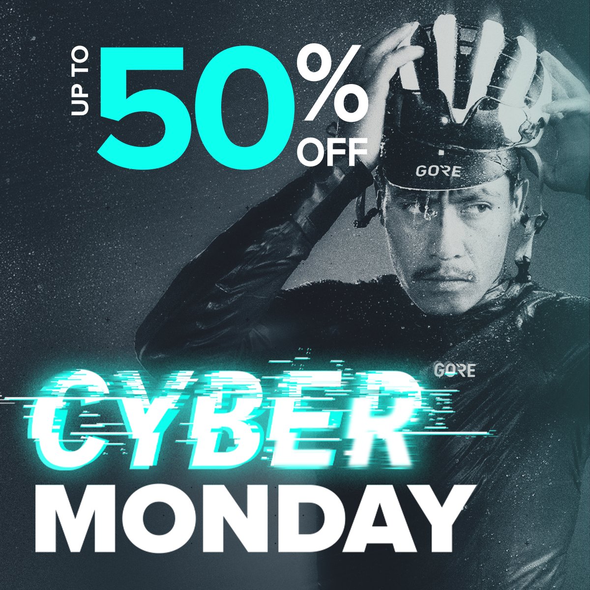 A blurry black and white photo of two sprinting cyclists. Huge cyan text reads “Cyber Monday: up to 50% off.”