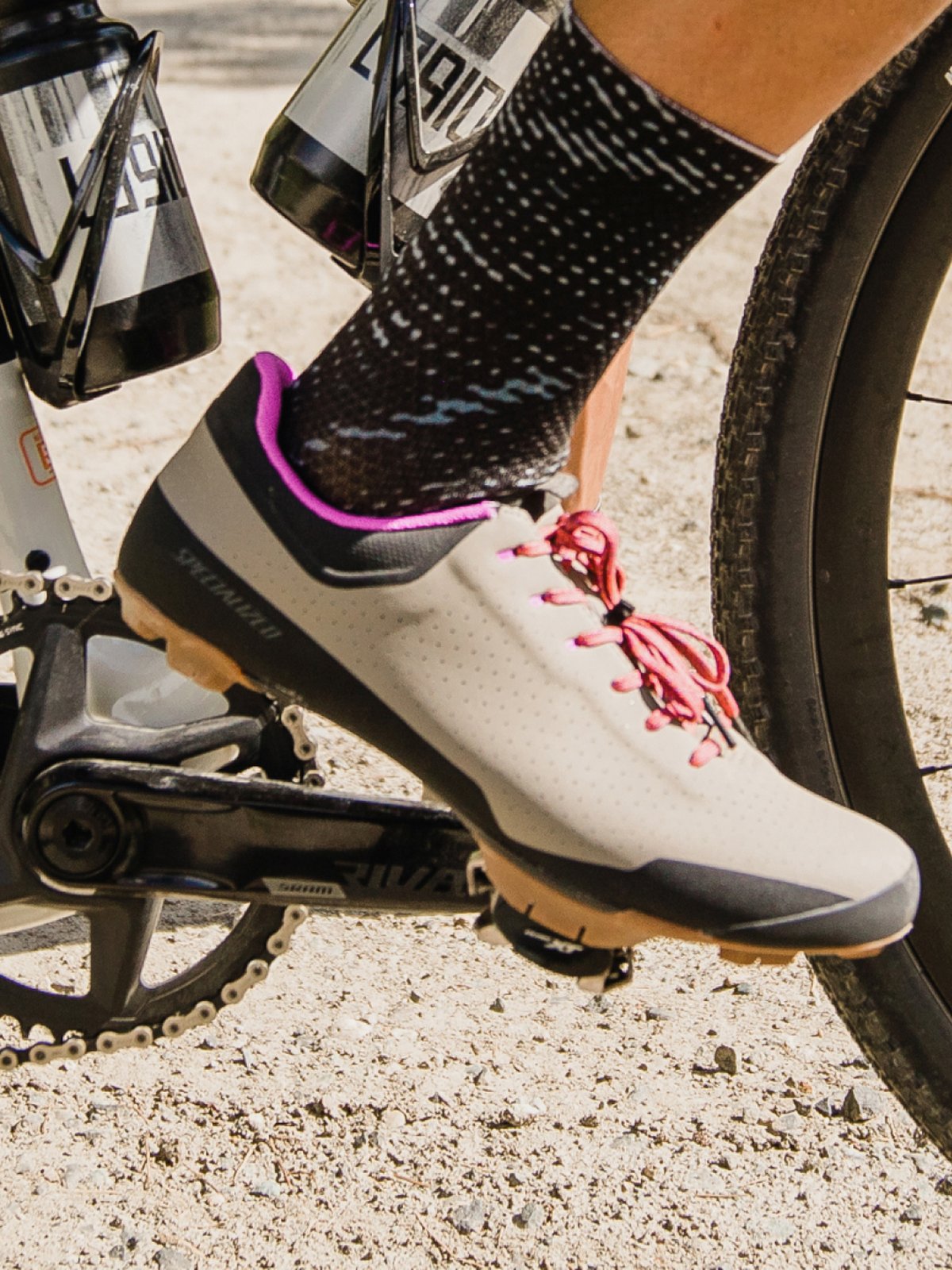 A rider’s gravel shoe clipped into a pedal.