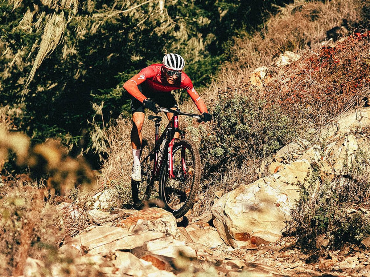XC cyclist riding rocky technical section of a trail.