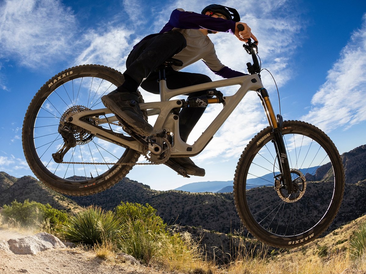 A mountain biker getting some air on a desert trail.