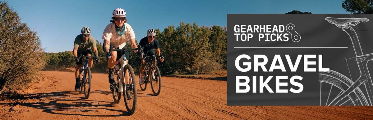 Two gravel bikers blur by on a dirt road.