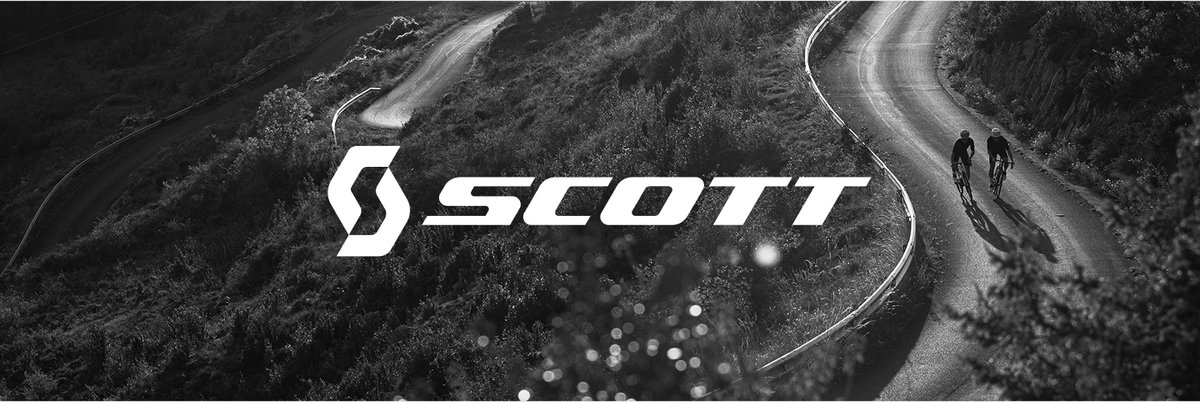Black and white photo of winding road and two cyclists riding on it Text overlay reads: Scott.
