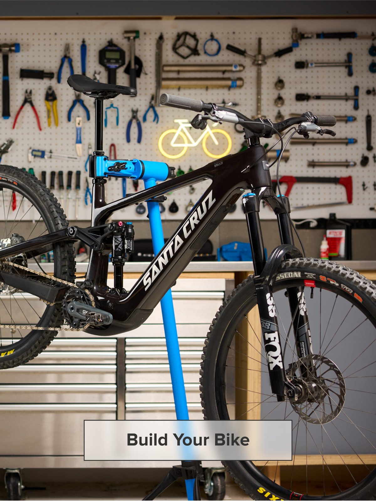 A bike in a shop rests on a stand ready to be worked on.