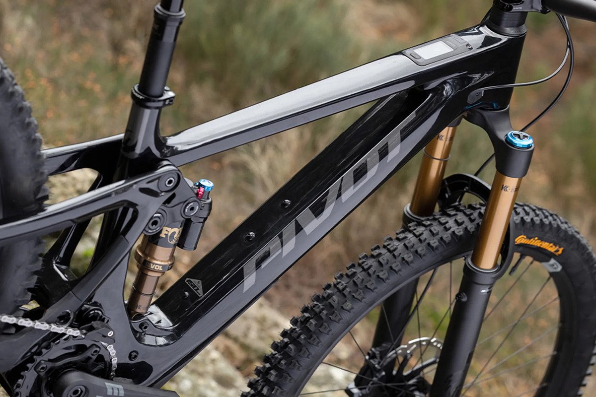 Pivot full-suspension mountain bike with Fox rear shock and gold fork staged on rocky dry terrain