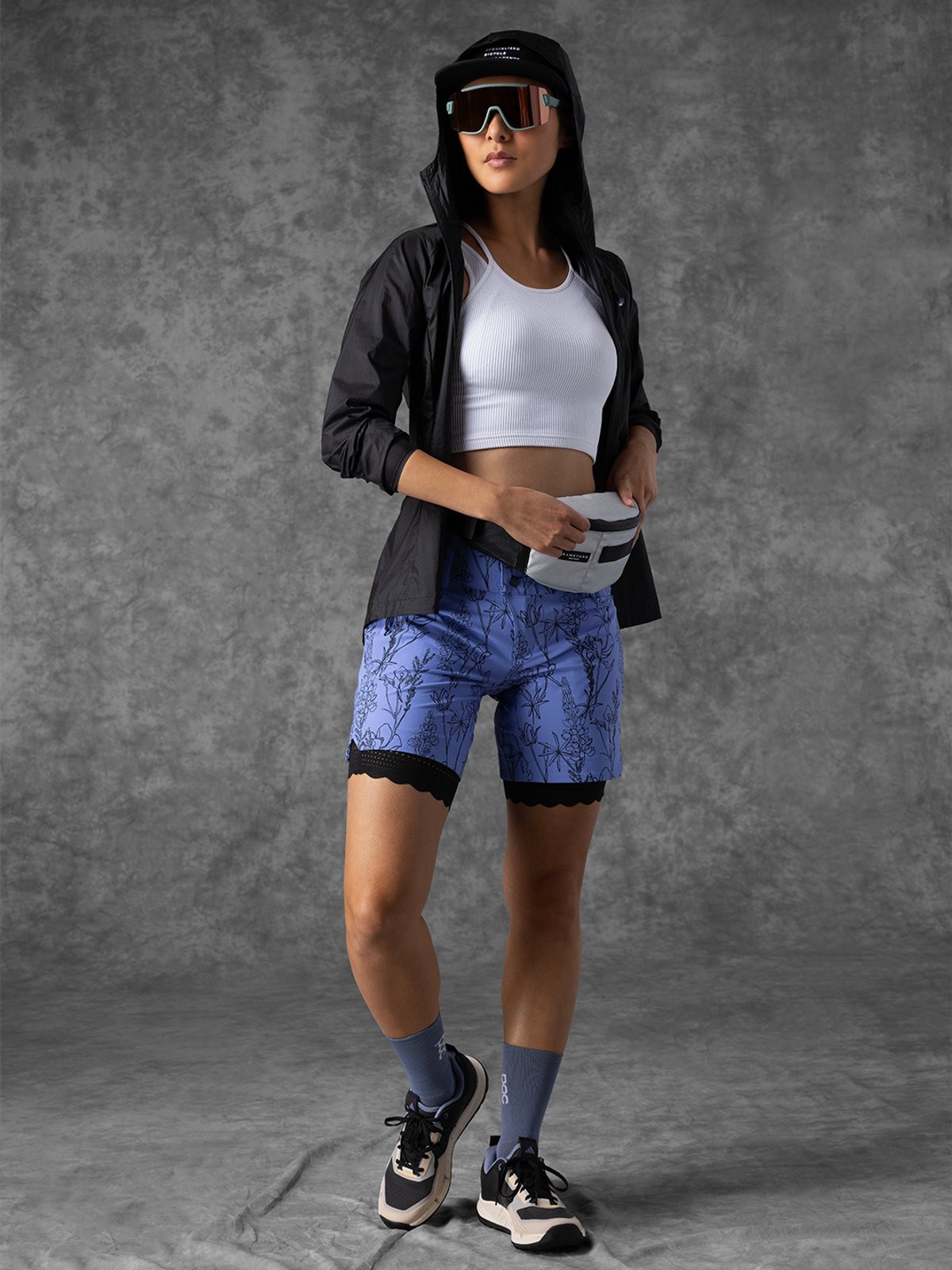 Women’s gravel MixFits kit #1 with a rider standing in the kit adjusting the hip pack.