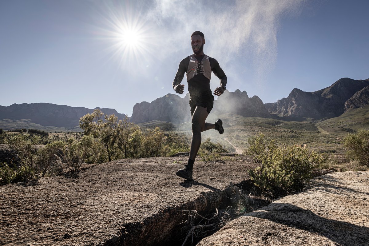 Person running with sun shining behind them.