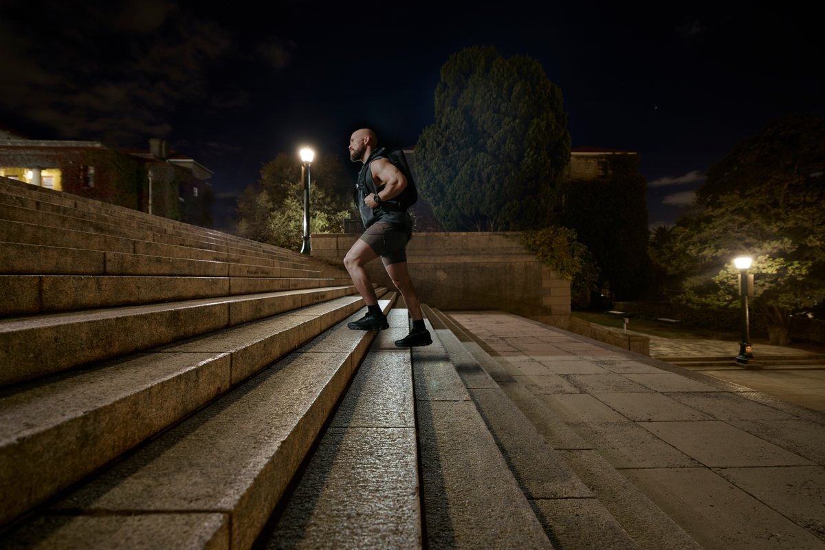 Person runnign up stairs in teh dark wearing Garmin Fenix 9 watch.