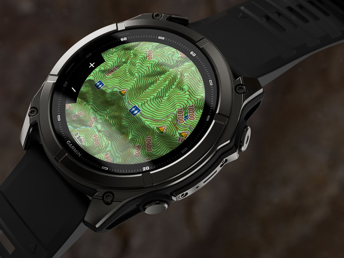 Close detail shot of Garmin Fenix 9 watch with topo map on screen.