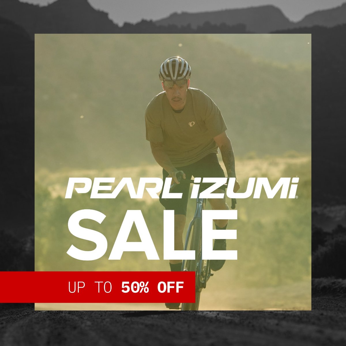 Pearl Izumi sale banner featuring a cyclist in a helmet and kit riding toward the camera on a dusty road. Up to 50% off.