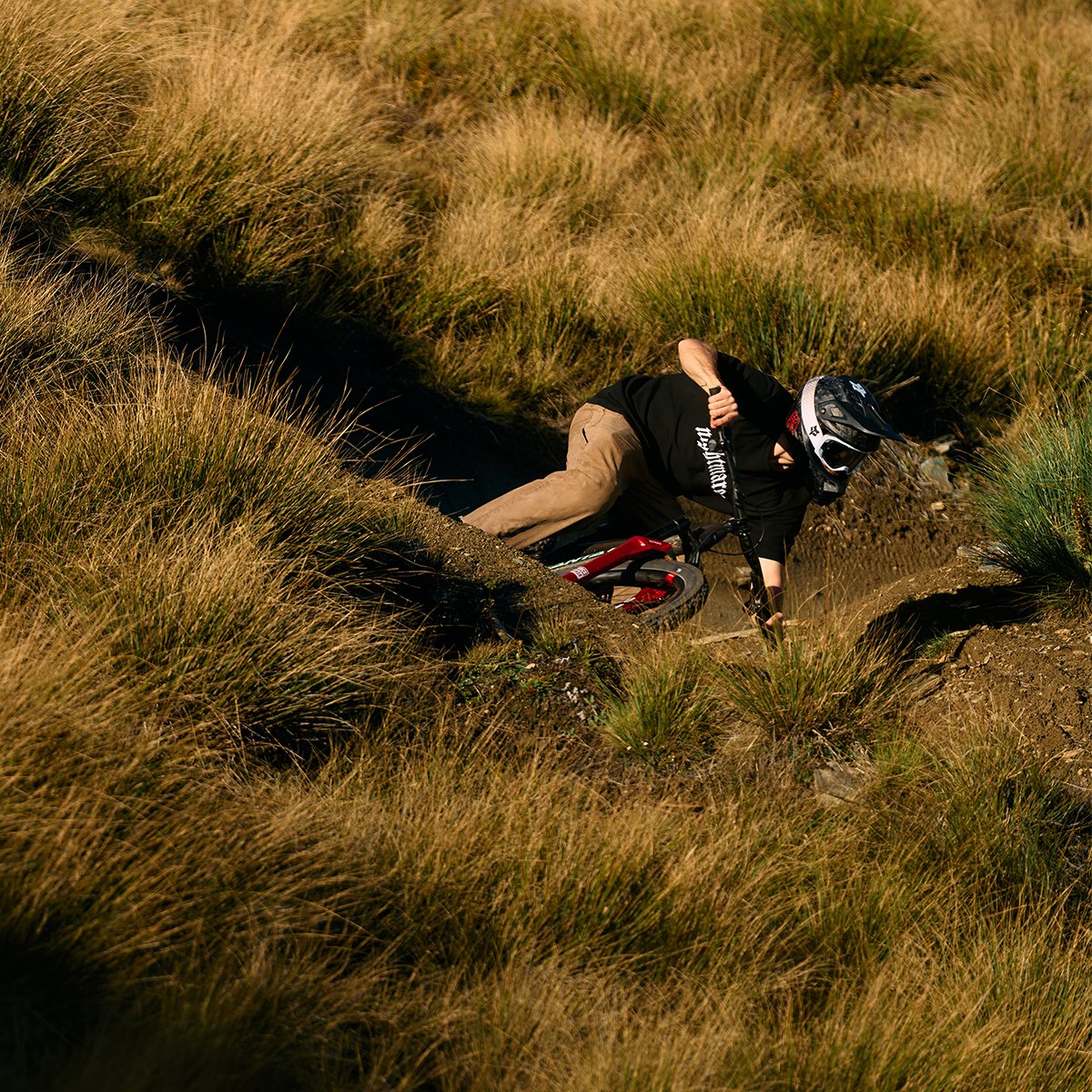 Person taking a downhill corner on the Santa Cruz Nomad Bike.