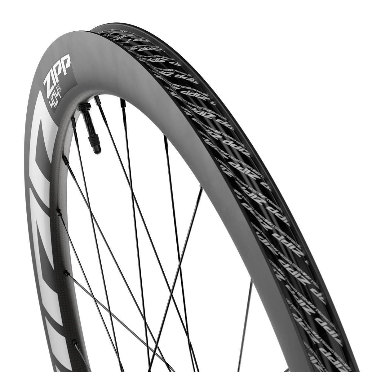 Close-up of the Zipp 404 carbon rim sidewall showing the tubeless-compatible bead channel and repeating Zipp text pattern.