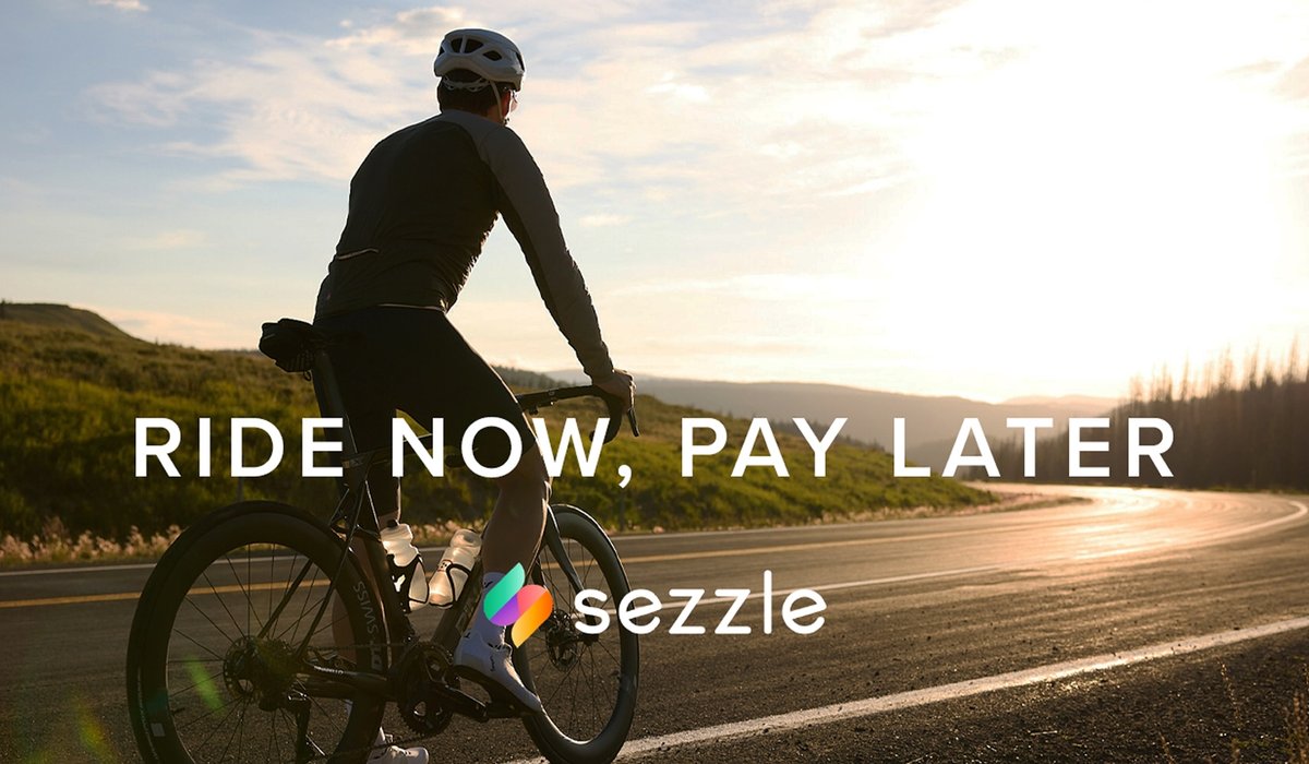 A cyclist riding into the sunset. The words, “Ride now, pay later. Sezzle.” are overlaid on the image.