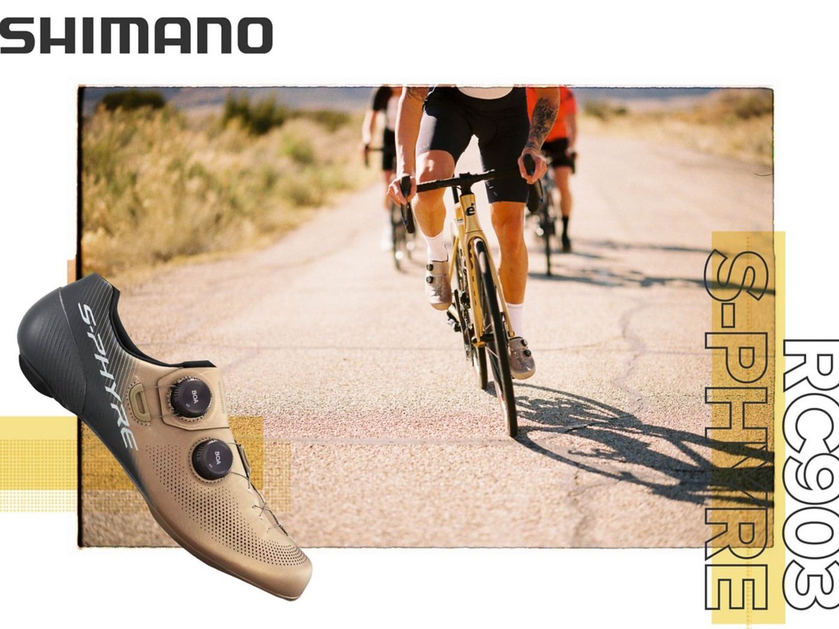 A gold and black Shimano RC903 shoe is shown in side-profile over an image of four road cyclists riding in a hilly region toward the camera.
