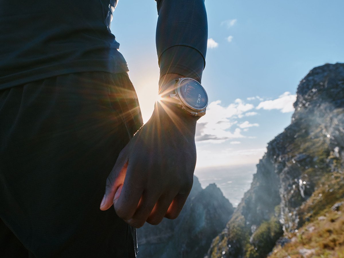 Person wearing Garmin Fenix 9 watch with sun shining from behind.