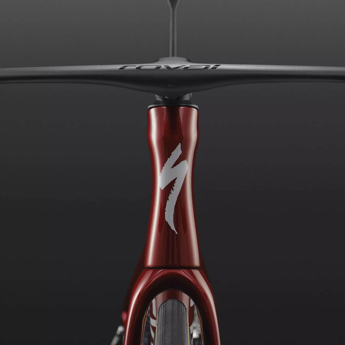 Front-on close-up of a red Specialized Tarmac SL9 head tube with white S-Works logo and Roval integrated handlebar, on a dark background.