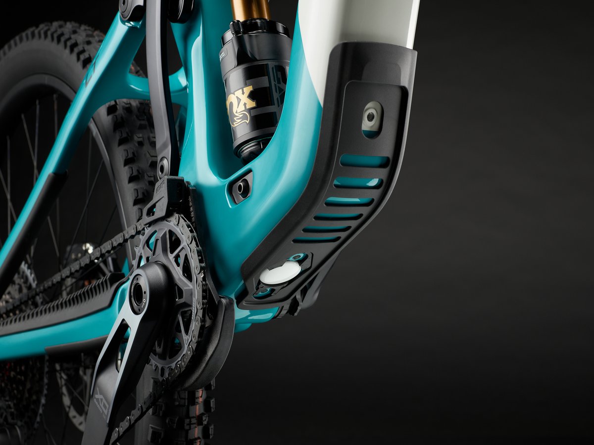 Close-up of a small mounting point and bolt on the frame near the shock, sized for an AirTag or Tile tracker.