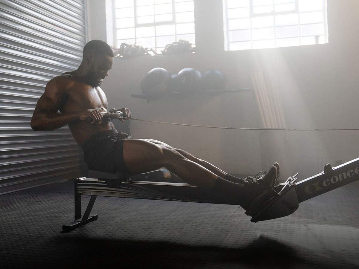 Person working out in a gym wearing Garmin Fenix 9 watch.