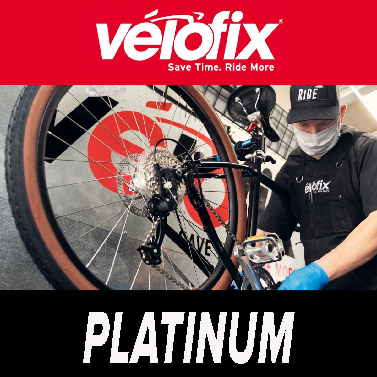 Velofix platinum tier. Shows a velofix technician working on a bike wheel & tire.