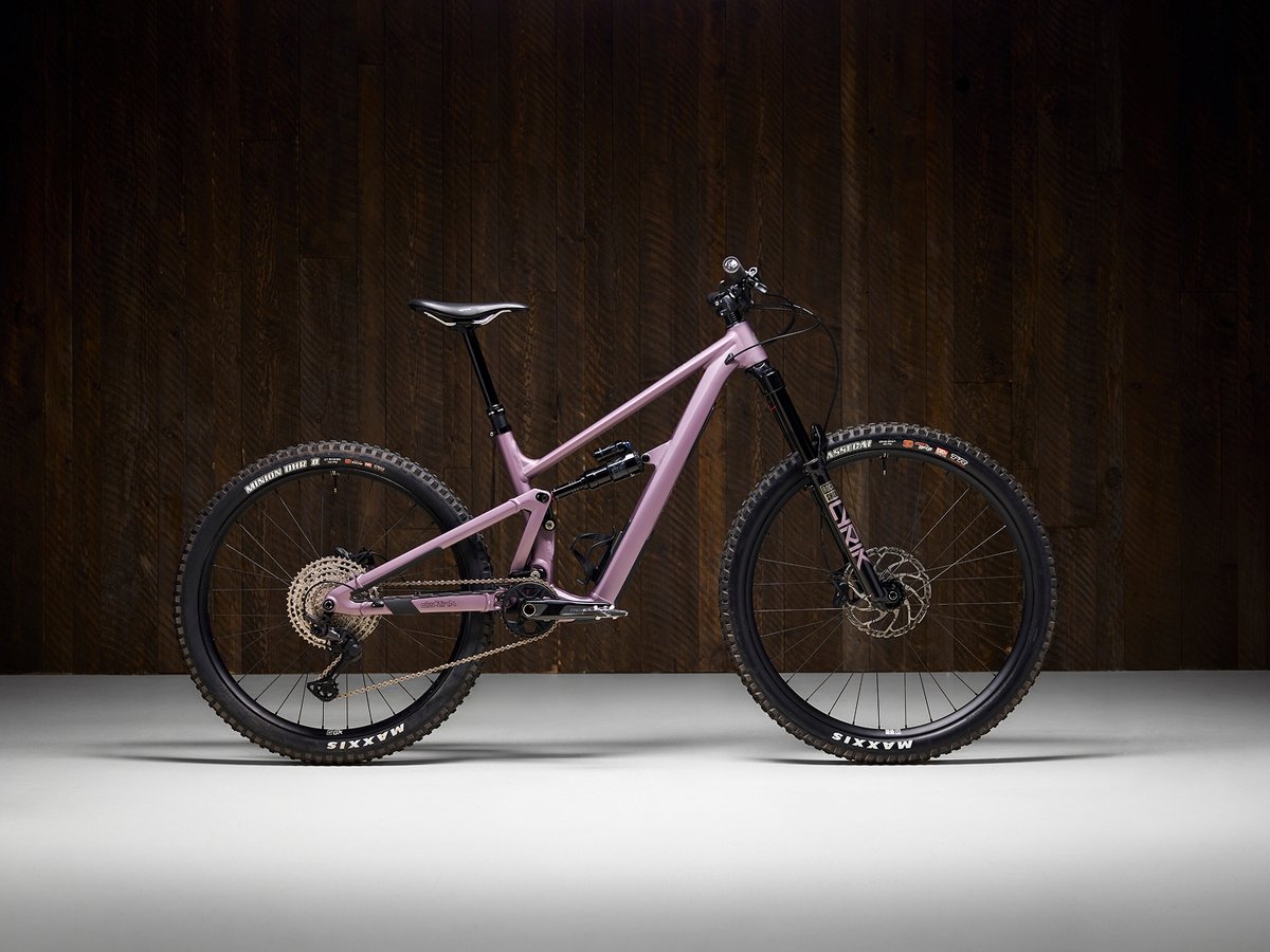 Ibis Ripmo AF mountain bike shown against a dark wood studio background.