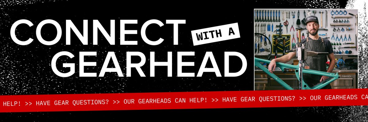 A black banner stretches across the page saying “Connect with a Gearhead” in large, friendly letters. An image of a man standing over a bike appears to the right of the banner. There’s a red ticker-style banner at the bottom saying, “Have gear questions? Our Gearheads can help!”