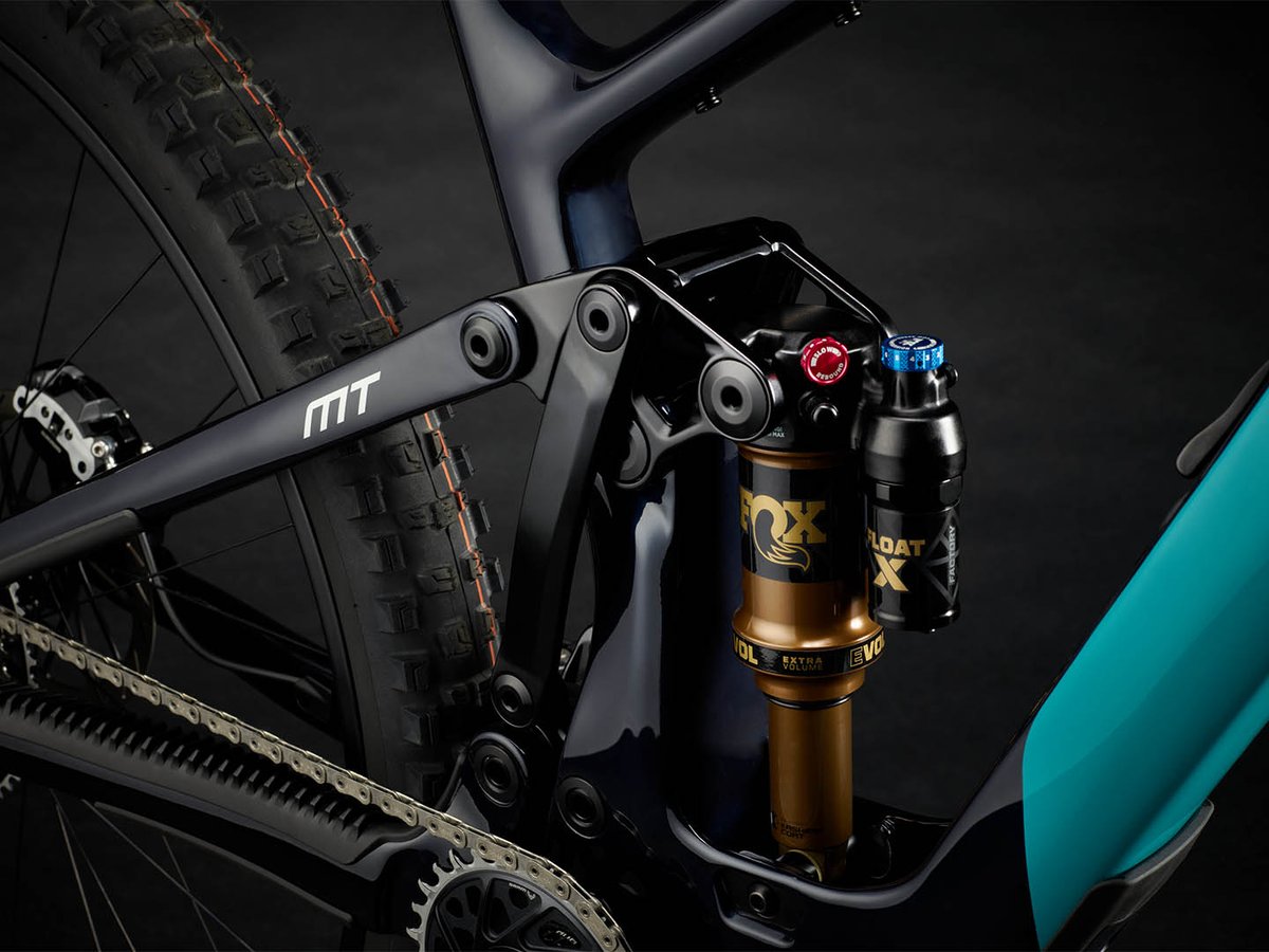 Close-up of the Yeti MT Sixfinity suspension linkage and Fox Float X Factory shock on the black-and-turquoise carbon frame.