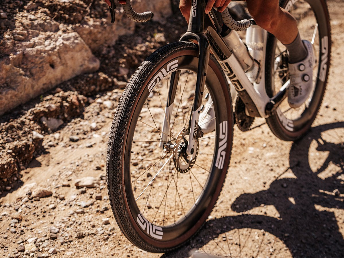 ENVE G SES carbon wheels on a gravel bike parked on rocky, sun-lit desert terrain.
