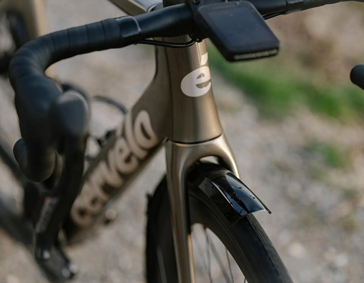 Close-up of a Cervélo road bike head tube, handlebars, and front wheel.