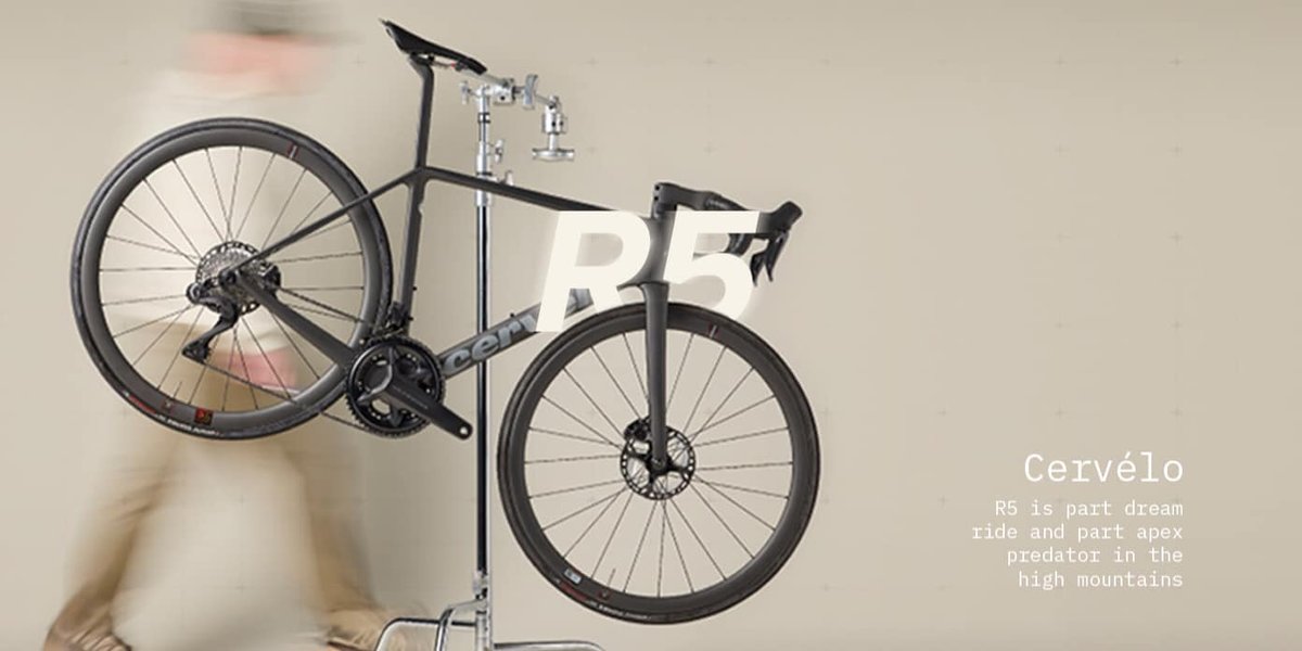 Cervelo R5 is part dream machine and part apex predator in the high mountains. A person walks around the bike in a workstand.