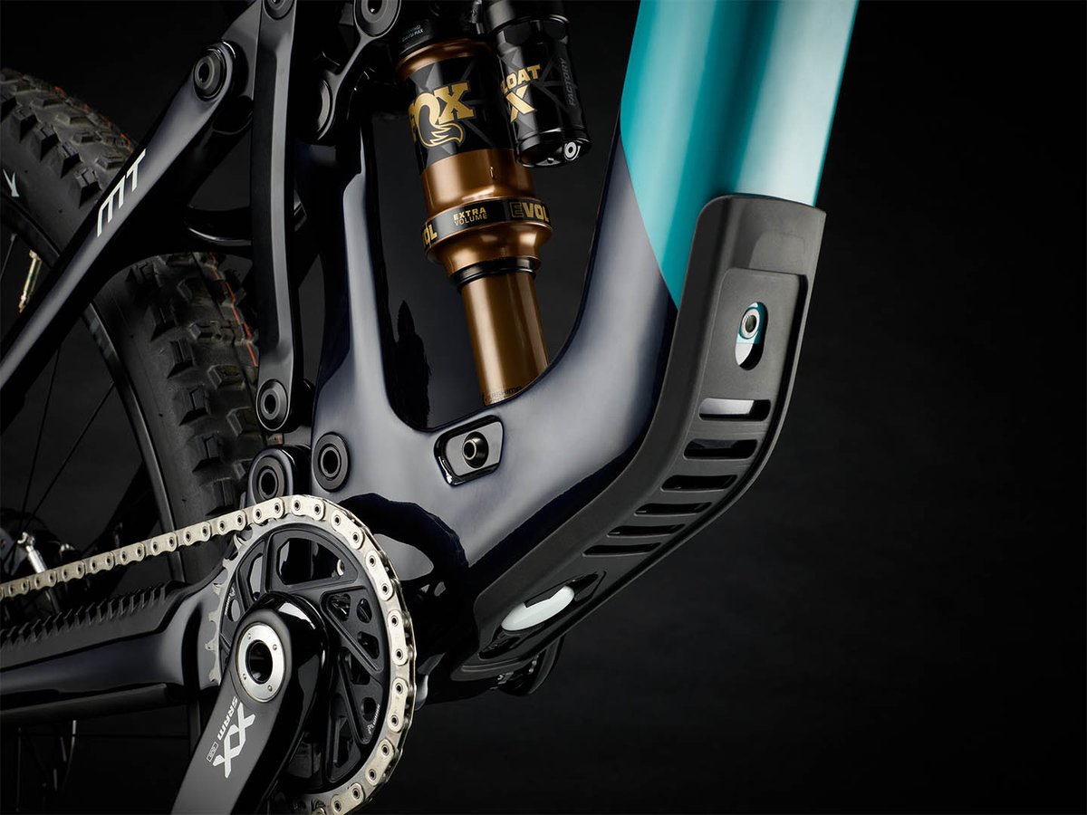 Bottom bracket area of the Yeti MT showing SRAM XX cranks, Fox Float X shock, and the molded downtube guard with a concealed tracker port.
